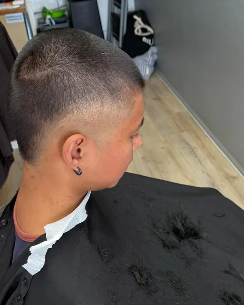 Buzz cut with a sharp fade around the ear