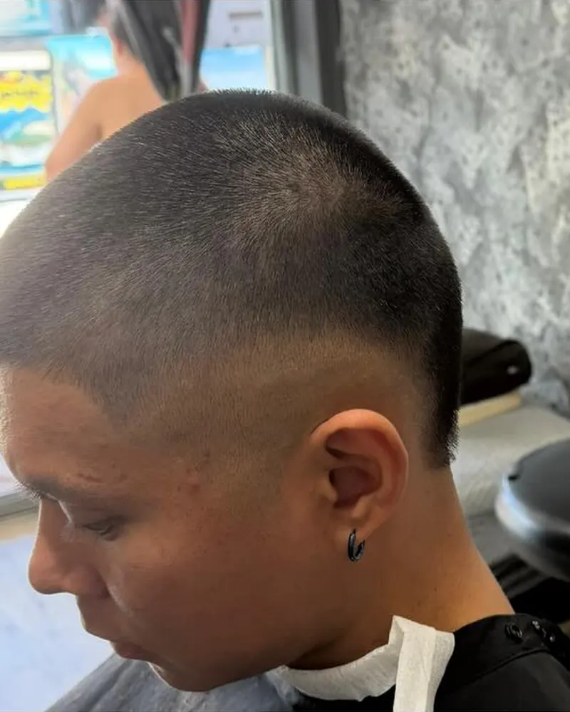 Short buzz cut with a high fade, side view
