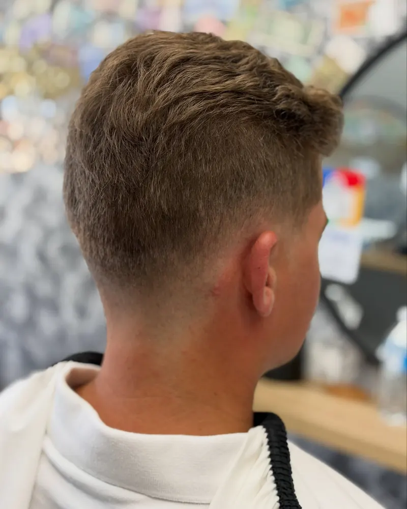Clean skin fade from behind with a textured crop, Airlie Beach barber