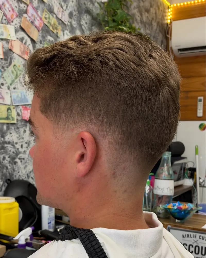 Low skin fade with a textured crop, side view